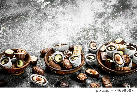 Chocolate candies in a bowls. Chocolate candies in a bowls. 74699087