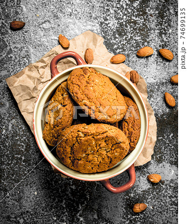 Oatmeal cookies in a bowl with nuts. Oatmeal cookies in a bowl with nuts. 74699135