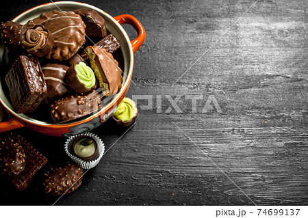 Chocolate candies in a bowl. . Chocolate candies in a bowl. . 74699137