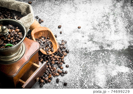 hand grinder with coffee beans. hand grinder with coffee beans. 74699229