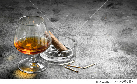 glass of cognac with a cigar. glass of cognac with a cigar. 74700087