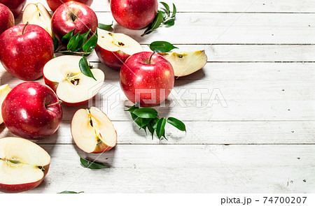 Fresh red apples with leaves. 74700207