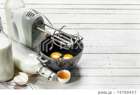 Baking background. Fresh eggs with a mixer. 74700457