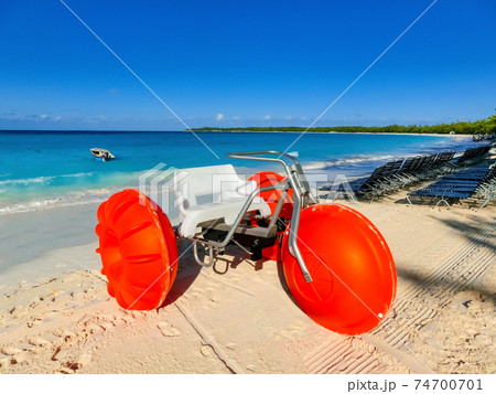 Colorful sailboats and motorboat, on a tropical beach at Half Moon Cay in the Bahamas Colorful sailboats and motorboat, on a tropical beach at Half Moon Cay in the Bahamas 74700701