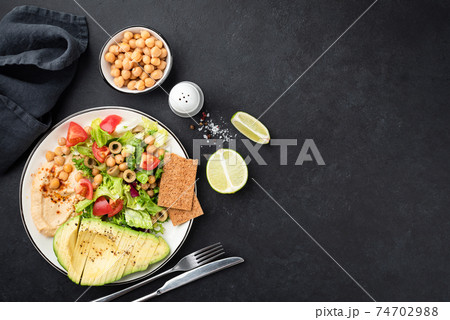 Healthy salad bowl with avocado and chickpeas 74702988