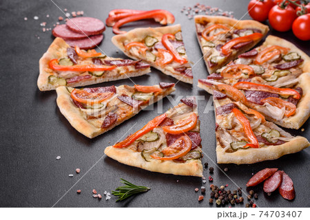 Fresh delicious pizza made in a hearth oven with sausage, pepper and tomatoes Fresh delicious pizza made in a hearth oven with sausage, pepper and tomatoes 74703407