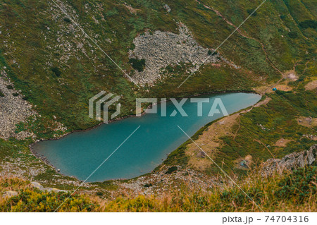 Lake Brebeneskul in the clouds, a view of the lake from the Montenegrin ridge, high-altitude ecologically clean lake in the Carpathians, a nature reserve. 74704316