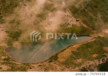 View from Mount Gutyn Tomnatyk to Lake Brebeneskul, a lake in the valley of the Carpathian Mountains, the highest lake in Ukraine. 74704318