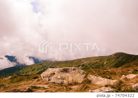 At the top of the mountain Gutyn Tomnatyk, the view from the mountain on the Montenegrin overcast ridge, breathtaking landscapes, enchant with their grandeur. 74704322