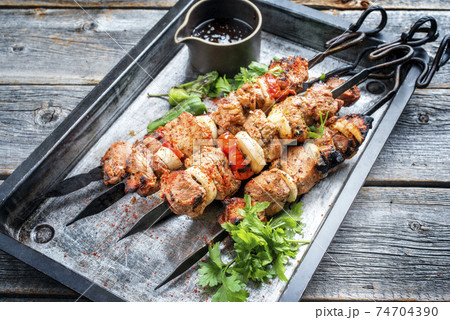 Greek souvlaki barbecue skewer with tomato, onion and paprika 74704390