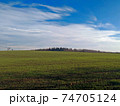 Scenic view on the countryside with a cloudy blue sky 74705124