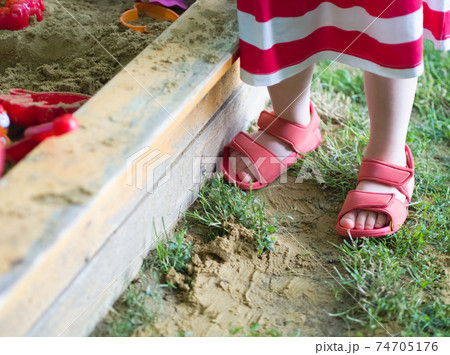 Little Girl at the Sandbox Closeup 74705176
