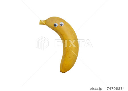 Ripe Kepok banana looks close up. Banana with eyes on white background. Funny banana. 74706834