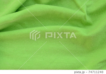 The texture of the fabric is bright green. Material for making shirts and blouses 74711240