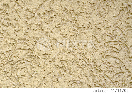 The texture of the beige decorative plaster in bark beetle style The texture of the beige decorative plaster in bark beetle style 74711709