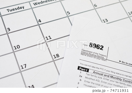 IRS Form 8962 Premium tax cerdit PTC blank lies on empty calendar page 74711931
