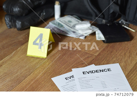 Evidence Chain of Custody Labels lies with big heroin packets and packs of money bills as evidence in crime scene investigation process Evidence Chain of Custody Labels lies with big heroin packets and packs of money bills as evidence in crime scene investigation process 74712079