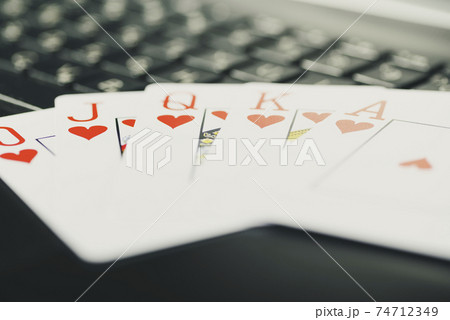 Online gaming platform, casino and gambling business. Cards, dice and multi-colored game pieces on laptop keyboard Online gaming platform, casino and gambling business. Cards, dice and multi-colored game pieces on laptop keyboard 74712349