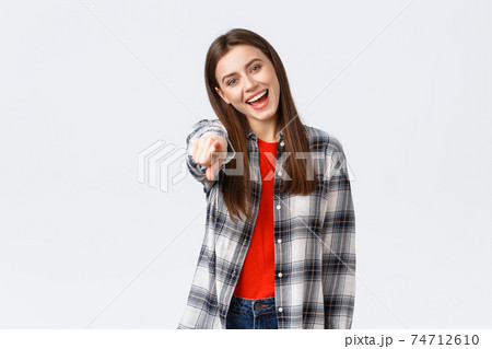 Lifestyle, different emotions, leisure activities concept. Carefree friendly happy girl pointing at camera, picking you, congratulating. HR female employee found perfect job, smiling enthusiastic 74712610