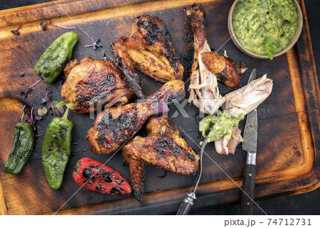 Caribbean barbecue chicken wings and drumsticks with chimichurri sauce, 74712731