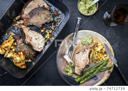 Exotically barbecue veal back racks squares roast with green asaparagus and pineapple 74712739