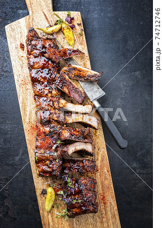 Tradtional barbecue spare ribs baby back style with hot honey chili marinade Tradtional barbecue spare ribs baby back style with hot honey chili marinade 74712746