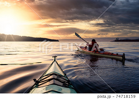 Adventurous Man Sea Kayaking in the Pacific Ocean. Adventurous Man Sea Kayaking in the Pacific Ocean. 74718159