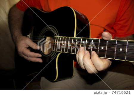 The fretboard of an old acoustic guitar The fretboard of an old acoustic guitar 74719621