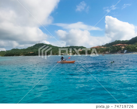 Dark clouds over Roatan island beache 74719726