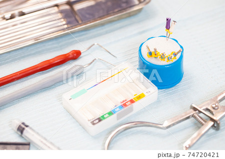dental equipment and instruments on a sterile table. root canal treatment instruments 74720421