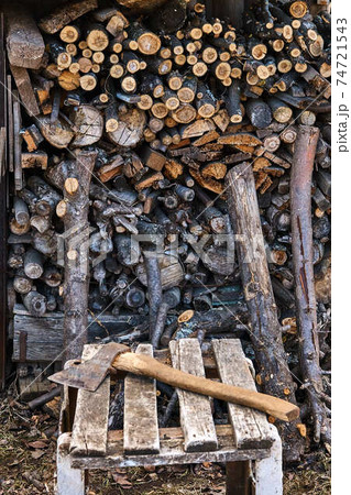 Hatchet lying on boards on the background of firewood 74721543
