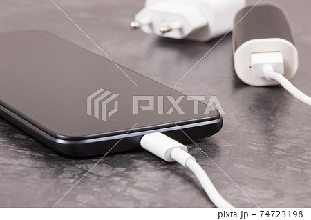 External powerbank charging empty battery of smartphone or mobile phone 74723198