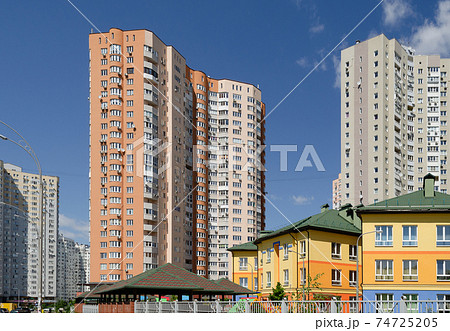 Modern residential apartment with flat buildings exterior. Detail of New luxury house and home complex. Part of City Real estate property and condo architecture. Blue sky 74725205