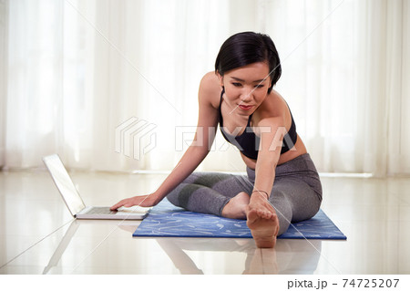 Woman doing stretching exercise 74725207