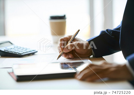 Businessman pointing at line chart 74725220