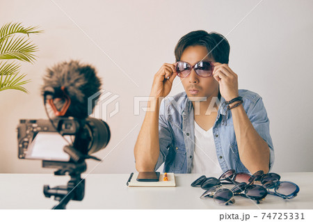 Asian Vlogger or Blogger Wear Pink Fashion Glasses to Show Customer in Vintage Tone Asian Vlogger or Blogger Wear Pink Fashion Glasses to Show Customer in Vintage Tone 74725331