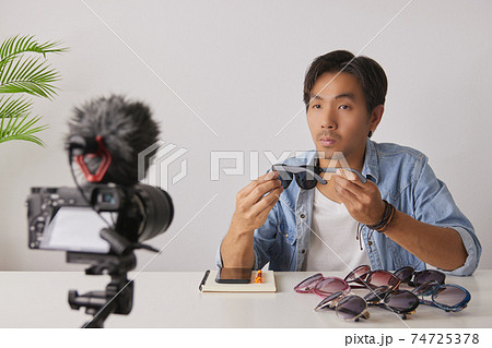 Asian Vlogger or Blogger Review Black Fashion Glasses and Recording Video 74725378