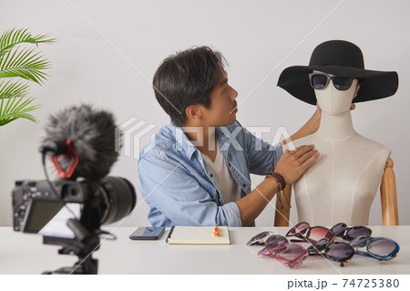 Asian Vlogger or Blogger Put Fashion Glasses to Mannequins and Recording Video 74725380