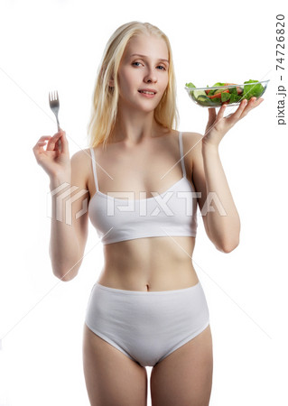 beautiful young woman with salad, isolated on white 74726820