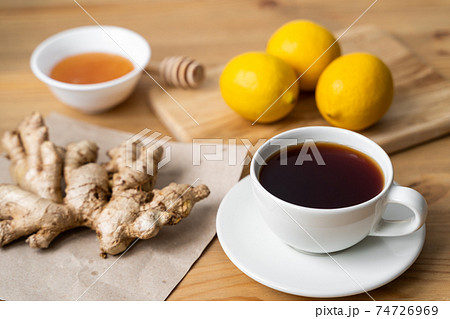 Cup of ginger tea with lemon on wooden table Cup of ginger tea with lemon on wooden table 74726969