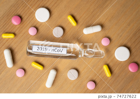 The Glass of water and medicine capsule on white background 74727622