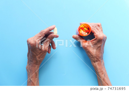 top view of senior women taking medicine  74731695