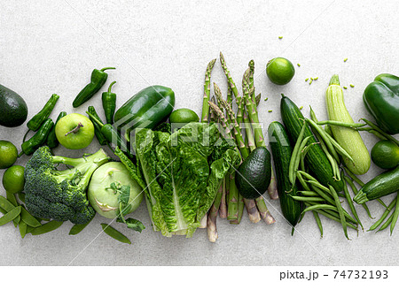 Green vegetables. Fresh green produce. Healthy vegetarian food concept background. Flat lay. Top down view Green vegetables. Fresh green produce. Healthy vegetarian food concept background. Flat lay. Top down view 74732193