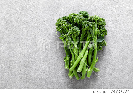 Broccolini. Fresh bunch of broccoli sprouts on a cooking table. Healthy food concept. Top view 74732224