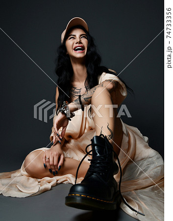 Laughing pretty sexy woman with tattoo on arm and 74733356