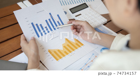 Financial businessmen analyze the graph of the company's performance to create profits and growth, Market research reports and income statistics, Financial and Accounting concept. Financial businessmen analyze the graph of the company's performance to create profits and growth, Market research reports and income statistics, Financial and Accounting concept. 74734157