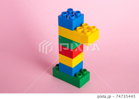 Color plastic building blocks on pink background 74735445