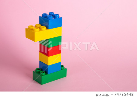 Color plastic building blocks on pink background 74735448