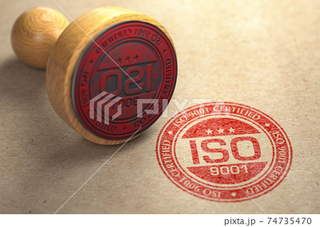 ISO 9001 certified concept. Rubber stamp with the text ISO 9001 on craft paper background. Quality control. 74735470