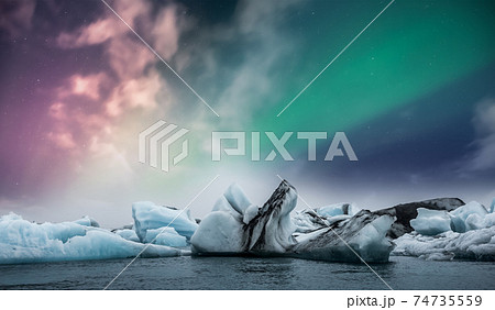 Northern lights aurora borealis over Jokulsarlon glacier ice lagoon in Iceland 74735559